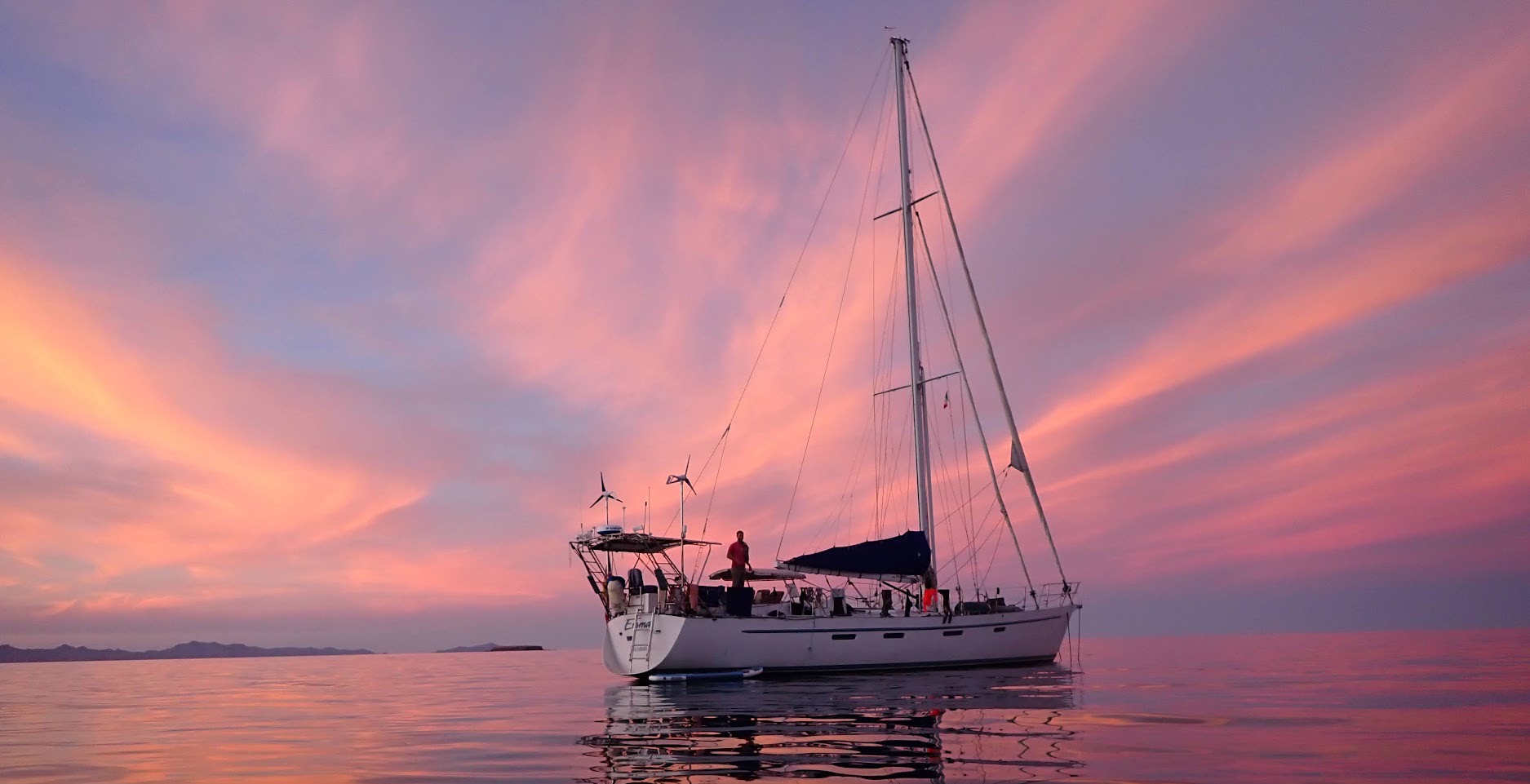 Emma at anchor beneath a pink and violet sunset